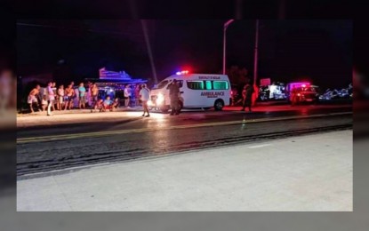 <p><strong>SCENE RESPONDERS.</strong> An ambulance and police patrol car respond to a grenade blast incident along the national highway in Matalam, North Cotabato late Wednesday (Dec. 15, 2021) that injured three, including a minor. A manhunt is underway against the perpetrators who fired at the victims before tossing a grenade. <em>(Photo courtesy of Matalam MPS)</em></p>