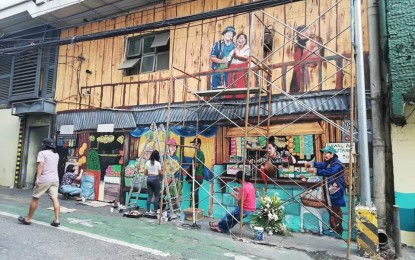 <p><strong>ART ALIVE. </strong>Young artists in Baguio City create a mural on buildings at the Central Business district in this undated photo. Rep. Mark Go on Thursday (Dec. 16, 2021) said he is hopeful that the talents of the city will be further honed with the passage of House Bill 10556 which seeks the creation of the Baguio Arts School. <em>(PNA photo by Liza T. Agoot)</em></p>