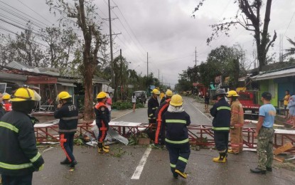 <p><strong>AFTERMATH.</strong> The Bureau of Fire Protection in Region 6 (Western Visayas) presides over road-clearing operations in this photo uploaded on Facebook on Friday (Dec. 17, 2021). Typhoon Odette is still in Palawan as of Friday night and is forecast to exit the Philippine Area of Responsibility Saturday morning (December 18) or early afternoon. <em>(Photo courtesy of BFP Facebook)</em></p>