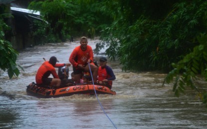 <p><strong>RESCUE.</strong> Personnel from the Phil. Coast Guard District Northern Mindanao rescue stranded residents living near the flooded Bitan-ag Creek in Cagayan de Oro City as Typhoon Odette makes landfall in Mindanao Thursday afternoon, Dec. 16, 2021. The city recorded zero casualties in the aftermath of the typhoon. <em>(PNA photo by Jigger Jerusalem)</em></p>