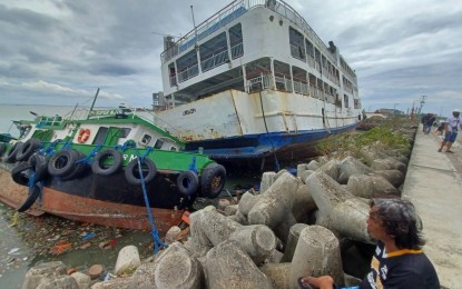 <p><strong>AFTERMATH.</strong> The passenger vessel MV Kho Ferry 1 and the tugboat MT Super MJ run aground at the coast of the South Road Properties in Cebu City, after Typhoon Odette struck Cebu province on Thursday evening (Dec. 16, 2021). Local government units in Cebu are now assessing the vast expanse of the damage left by "Odette." <em>(PNA photo by John Rey Saavedra)</em></p>