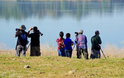 <p><strong>BIRDING</strong>. Local birdwatchers and photographers visit Paoay Lake for the yearly Asian bird census in this undated photo. a birdwatching tour circuit was launched on Friday (Dec. 17, 2021) at the Paoay Lake Natural Park in Nanguyudan village, Paoay town, considered as one of the migratory bird sites in the country. <em>(Photo courtesy of Ilocos Norte Tourism)</em></p>