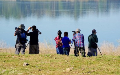 <p><strong>BIRDING.</strong> Local birdwatchers and photographers visit Paoay Lake for the yearly Asian bird census in this undated photo. A birdwatching tour circuit was launched Dec. 17, 2021 at the Paoay Lake Natural Park in Nanguyudan village, Paoay town, considered one of the migratory bird sites in the country.<em> (Photo courtesy of Ilocos Norte Tourism)</em></p>