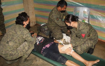 <p><strong>CASUALTY.</strong> Medics of the 97th Infantry Battalion provide first aid to Antonia Morato, a New People's Army rebel who was captured with two others following a clash in Zamboanga del Norte amid the onslaught of Typhoon Odette on Friday (Dec. 17, 2021). Morato and another wounded rebel, Villamor Galleon, were brought to the Zamboanga del Norte Medical Center. <em>(Photo courtesy of 97IB)</em></p>