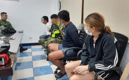 <p><strong>ARRESTED.</strong> The four Taguig City cops involved in a home robbery incident in Barangay Kapitolyo, Pasig City on Saturday (Dec. 18, 2021) are now under restrictive custody. They are among eight suspects, including a female civilian (right), who reportedly robbed a Japanese national and his Filipina partner of PHP30 million in cash. <em>(Photo courtesy of NCRPO)</em></p>