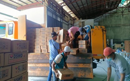 <p><strong>NEEDED FOOD.</strong> At least 10,000 family food packs (FFPs) from the Department of Social Welfare and Development in Caraga are being prepared at its loading station in Butuan City on Sunday (Dec.19, 2021) for delivery to local government units in the disaster-hit Province of Dinagat Islands and in Siargao Island in Surigao del Norte. The agency said 48,000 more FFPs from the DSWD central office and its various offices will be arriving for areas in the region badly hit by Typhoon Odette last week.<em> (Photo courtesy of DSWD-13)</em></p>