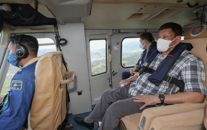 <p><strong>AERIAL SURVEY</strong>. President Rodrigo Roa Duterte conducts an aerial survey of areas severely affected by Typhoon Odette in the towns of Cebu and Bohol on Dec. 19, 2021. He was accompanied by Senator Bong Go. <em>(Presidential photo by Simeon Celi)</em></p>