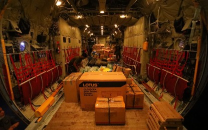 <p><strong>RELIEF FOR CEBU.</strong> Boxes of relief goods are loaded into a Philippine Air Force C-130 aircraft at the Villamor Air Base in Pasay City on Sunday (Dec. 19, 2021). The Air Force conducted two sorties where a total of 33,797 pounds of relief goods were transported. <em>(Photo courtesy of PAF)</em></p>