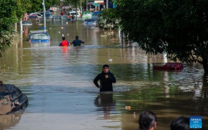 <p><strong>MALAYSIA FLOODS</strong>. Flood victims wade through a flooded road in Shah Alam, Selangor, Malaysia on Monday (Dec. 20, 2021). Eight people have been reported dead due to severe flooding in Malaysia as of Monday, authorities in Selangor state said. <em>(Photo by Chong Voon Chung/Xinhua)</em></p>
