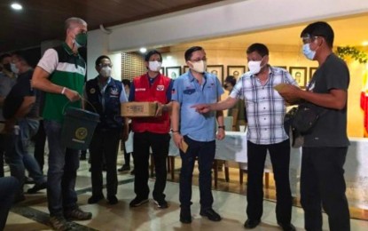 <p><strong>TYPHOON AID</strong>. President Rodrigo Duterte (2nd from right) leads the ceremonial turnover of 10,450 family food packs worth PHP5.7 million provided by the Department of Social Welfare and Development to typhoon-hit areas in southern Negros Occidental during his visit to Kabankalan City on Monday afternoon (Dec. 21, 2021). He is joined by Senator Christopher Lawrence “Bong” Go (3rd from right), Negros Occidental Governor Eugenio Jose Lacson (left), Social Welfare Secretary Rolando Bautista (3rd from left) and Health Secretary Francisco Duque III (2nd from left).<em> (Photo courtesy of DSWD-Western Visayas)</em></p>