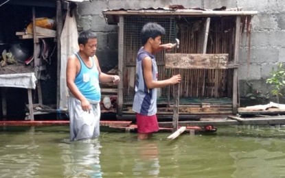 <p><strong>FAMILY EFFORT.</strong> A father-son tandem repairs their home in Pikit, North Cotabato after floodwaters begin to recede on Tuesday (Dec. 21. 2021), days after Typhoon Odette slammed the Northern Mindanao Region, devastating cities and provinces along its path. At least 19,000 individuals were affected by floods spawned by heavy rains in the province due to the typhoon. <em>(Photo courtesy of Ameril Bacar/Pikit MDRRMO)</em></p>
