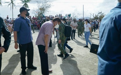 <p><strong>WORKING HOLIDAY</strong>. President Rodrigo Duterte bows as a gesture of respect as he visits families affected by Typhoon Odette at an evacuation center on Siargao Island, Surigao del Norte on Dec. 22, 2021. Duterte said Thursday (Dec. 23, 2021) he would spend the holidays working to ensure that communities battered by “Odette” would receive their much-needed assistance. <em>(Presidential photo by King Rodriguez)</em></p>