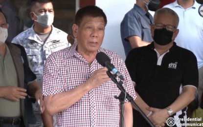 <p><strong>THANK YOU, QATAR.</strong> President Rodrigo Duterte speaks during his visit to typhoon victims in Siargao Island, Surigao del Norte on Wednesday (Dec. 22, 2021). The President thanked Qatar's Emir, Sheikh Tamim bin Hamad Al Thani for his country's offer of assistance to typhoon victims. <em>(Screengrab from RTVM)</em></p>