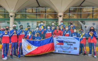 <p><strong>PH PRIDE.</strong> The 17-member Philippine delegation that brought home 19 gold, 19 silver, and seven bronze medals from the 9th Mombasa Open Tong-Il Moo Do International Martial Arts Championship 2021 leave host country Kenya for home on Thursday (Dec. 23, 2021). They were sent off by Philippine Embassy Chargé d’affaires, ad interim, Maria Rosanna Josue (7th from left) at Jomo Kenyatta International Airport in Nairobi <em>(Contributed photo)</em></p>