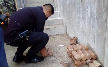 <p><strong>UNEXPLODED ORDNANCE</strong>. An explosive ordnance demolition (EOD) policeman arranges the unexploded ordnance unearthed at a construction site in Barangay Cabatangan, Zamboanga City on Thursday (Dec. 23, 2021). Lt. Mary Agnes Miro, Zamboanga City Police information office, on Saturday (Dec. 25, 2021) advised homeowners and workers to be cautious while working in construction sites to avoid accidental explosions. <em>(Photo courtesy of Jerry Amaga)</em></p>