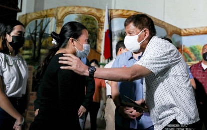 <p><strong>POST-TYPHOON EFFORTS.</strong> President Rodrigo Duterte talks with a survivor of Typhoon Odette in Barangay Tisa, Cebu City on Thursday (Dec. 23, 2021). It was during his command conference with officials in the province that he reiterated the government will stay neutral in the China-Taiwan row. <em>(Alfred Frias / Presidential photo)</em></p>