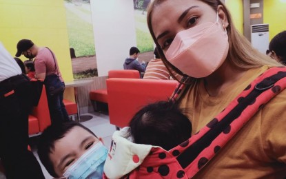 <p><strong>PROTECTION.</strong> Julie Christine Indoyon (right), with her three-year-old son in an undated photo, is seen wearing a face mask as they went to a shopping mall in Davao City. Indoyon stressed the need for parents to practice requiring their kids to wear face masks to get protected from the coronavirus threat. <em>(Photo courtesy of Julie Christine Indoyon)</em></p>