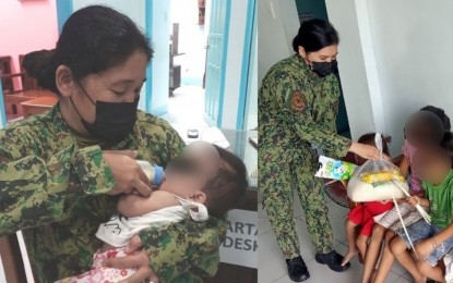 <p><strong>MOTHERLY COPS.</strong> Two lady police officers attend to the needs of four children abandoned by their parents in the premises of a church in Libungan, North Cotabato on Dec. 25, 2021. The two cops had been receiving praises on social media and from fellow police officers. <em>(Photo courtesy of Libungan MPS)</em></p>