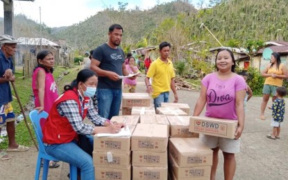 <p><strong>FOOD AID</strong>. Boxes of family food packs are distributed in Hinunangan, Southern Leyte on Dec. 27, 2021. At least 53,389 family food packs have been distributed by the Department of Social Welfare and Development to victims of Typhoon Odette in 25 badly-hit towns in Eastern Visayas. <em>(Photo courtesy of DSWD-8)</em></p>