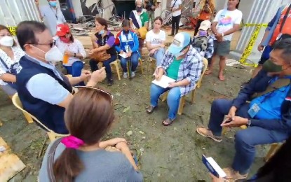 <p><strong>DAMAGE ASSESSMENT.</strong> Housing czar Secretary Eduardo del Rosario (left) consults with typhoon-affected families in Surigao City on Dec. 20, 2021. Del Rosario also toured Dinagat Island to check on residents and assess the extent of damage brought about by Typhoon Odette on December 16. <em>(Photo courtesy of DHSUD)</em></p>