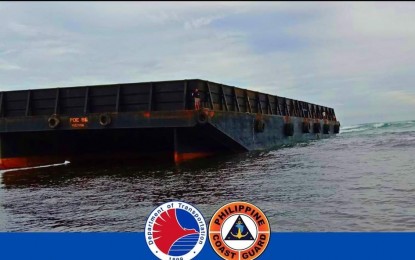 <p><strong>AGROUND.</strong> A barge runs aground at the coral sanctuary 1.5 nautical miles from the shoreline of Silaqui Island, Bolinao town, Pangasinan. The Philippine Coast Guard said Wednesday (Dec. 29, 2021) the assessment of the damage to the coral sanctuary is ongoing. <em>(Photo courtesy of Philippine Coast Guard)</em></p>
