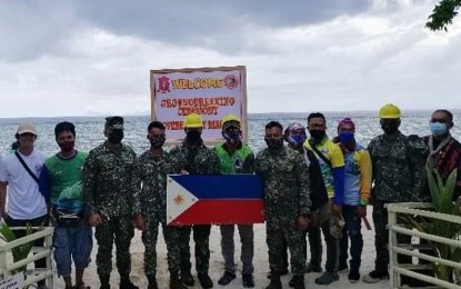 <p><strong>DOMINION MARKER.</strong> The 2nd Marine Brigade together with the municipal government of Sitangkai, Tawi-Tawi visit Panguan Island on Dec. 24, 2021, ahead of the construction of a sovereign marker on the remote island in the province that borders Malaysia and Indonesia. Brig. Gen. Romeo Racadio, 2nd Marine Brigade commander (5th from left), led the groundbreaking of the project. <em>(Photo courtesy of the 2nd Marine Brigade)</em></p>