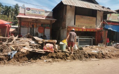 <p><strong>BANGON NEGOSYO.</strong> A man sifts through the rubble of what is left of his home in this Dec. 24, 2021 photo taken in Bindoy, Negros Oriental following the onslaught of Typhoon Odette. The Department of Trade and Industry in the province on Friday, Dec. 31, 2021, started distributing Bangon Negosyo livelihood kits for micro, small, and medium enterprises (MSMEs) that were devastated by the typhoon. <em>(Photo courtesy of Cil Flores)</em></p>