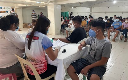 <p><strong>VAX FOR MINORS</strong>. Minors line up at the Laoag City General Hospital in this undated photo to get their second dose of Pfizer vaccine. All eligible residents are also encouraged to register for their booster shots and wait for their schedules. <em>(Photo by Leilanie G. Adriano)</em></p>