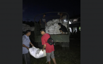 <p><strong>SEEDNUTS</strong>. Soldiers load sacks of coconut seednuts in the military trucks early Wednesday morning (Jan. 5, 2022). The Philippine Coconut Authority donated 15,000 seednuts to coconut farmers affected by Typhoon Odette in Palawan. <em>(Photo courtesy of PCA)</em></p>