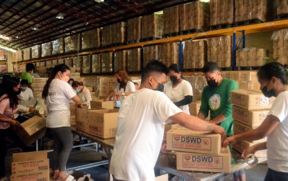<p><strong>FOOD AID</strong>. Personnel of the Department of Social Welfare and Development (DSWD) 3 (Central Luzon) ready family food packs to be distributed to victims of Typhoon Odette in the Visayas and Mindanao in this undated photo. More than PHP10 million worth of food and non-food items have been sent to thousands of affected families.<em> (File photo courtesy of DSWD-3)</em></p>