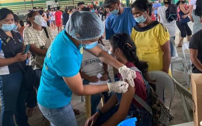 <p><strong>VACCINATED</strong>. A resident of Ilog town in Negros Occidental gets vaccinated against Covid-19 in early December last year. The vaccination campaign has resumed this week in areas badly hit by Typhoon Odette in southern Negros. <em>(File photo courtesy of Ilog Municipal Health Office)</em></p>
