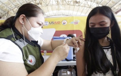 <p><strong>VAX EFFORTS</strong>. This undated photo shows a vaccinee getting a Covid-19 jab from a health worker. The Cebu City government on Friday (Jan. 7, 2022) said it is ramping up efforts in giving booster jabs to protect residents against the virus, particularly the Omicron variant.<em> (Photo courtesy of Cebu City News and Information Office)</em></p>