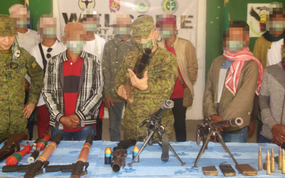 <p><strong>RETURN TO NORMAL LIFE.</strong> Col. Jovencio Gonzales, 602nd Infantry Brigade commander, inspects one of the seven firearms surrendered by 14 Bangsamoro Islamic Freedom Fighters (BIFF) members in Midsayap, North Cotabato on Friday (Jan. 7, 2021), as Lt. Col. Edgardo Vilchez Jr. (extreme left), the 34th IB commander, and the surrenderers look on. The latest batch of surrendering BIFF fighters said they were all longing to be reunited with their families. <em>(Photo courtesy of 6ID)</em></p>