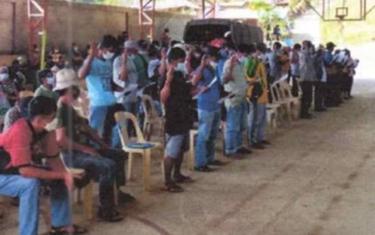 <p><strong>OATH OF ALLEGIANCE</strong>. Members of communist terrorist groups pledge allegiance to the government after their surrender to the Joint Task Force Kaugnay’s 81st Infantry Battalion at the covered court of Barangay Alfonso in Gregorio del Pilar, Ilocos Sur on Tuesday (Jan. 11, 2022). The Northern Luzon Command said a total of 130 communist terrorist group members and their supporters have returned to the fold of the law since Dec. 31, 2021. <em>(Photo courtesy of Northern Luzon Command)</em></p>