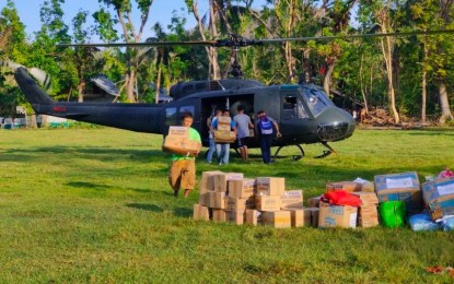 <p><strong>RELIEF OPS</strong>. An undated photo shows relief goods being unloaded from a UH-1H helicopter for Typhoon Odette-affected families in an undisclosed area. The Philippine Air Force has put on limited operations its UH-1H "Huey" combat utility helicopters that were earlier grounded and placed in storage to help in the ongoing relief efforts for typhoon victims.<em> (Photo courtesy of PAF)</em></p>