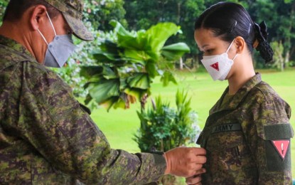 <p><strong>DONNING OF RANK.</strong> Maj. Gen. Generoso Ponio, 1st Infantry Division (ID) commander (left), pins the new rank to 2Lt. Ruth Elaine Aquino, who was promoted to 1st Lieutenant during the flag-raising ceremony Monday (Jan. 17, 2022) at Camp Cesar Sang-an, home of the 1ID headquarters in Labangan, Zamboanga del Sur. The donning of rank took place as Ponio welcomed four officers the Philippine Army has assigned to the 1ID.<em> (Photo courtesy of the 1ID)</em></p>