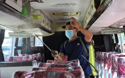 <p><strong>SAFETY.</strong> A worker sprays disinfectant on one of the buses owned by the Yanson Group of Bus Companies in Barangay Bulua, Cagayan de Oro, to ensure that it is safe for the riding public on Sunday (Jan. 16, 2022). The management of the public transport company, whose bus was bombed in North Cotabato recently, has expressed its gratitude to the military for the arrest of the bomb suspects. <em>(PNA photo by Jigger Jerusalem)</em></p>