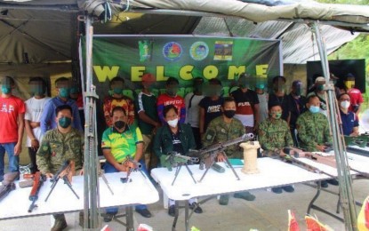 <p><strong>WEARY COMBATANTS</strong>. The 16 former Bangsamoro Islamic Freedom Fighters rebels pose with military and local officials following their formal presentation in Datu Unsay, Maguindanao on Monday (Jan. 17, 2022). The surrenderers said they returned to the folds of the law to start a new life due to the relentless military campaign against them in the province. <em>(Photo courtesy of 6ID)</em></p>