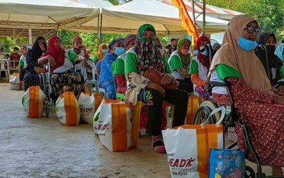 <p><strong>RELIEF ASSISTANCE.</strong> Widows of deceased Bangsamoro fighters sit and listen to the program in Pigcawayan, North Cotabato where the BARMM government launched Tuesday (Jan. 18, 2022) various development projects for residents of 12 villages that are now part of the autonomous government. A part of the program was dedicated to former Moro Islamic Liberation Front combatants who died during the more than two decades of struggle for self-determination in Mindanao where their widows received cash and relief aid from the regional government. <em>(Photo courtesy of MILG-BARMM)</em></p>