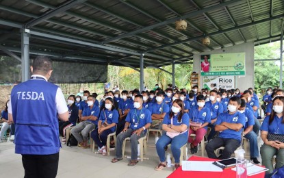 <p><strong>GRADUATES</strong>. Technical Education and Skills Development Authority-Cordillera regional director Jeffrey Ian Dy (back on camera) delivers a message to some 125 agricultural training graduates in Alfonso Lista, Ifugao on Jan. 12, 2022. Dy said the government continues to invest in technology and human resource by providing skills to farmers that can help improve their economic condition and boost the country’s food sustainability. <em>(Photo courtesy of Steff Peligman)</em></p>