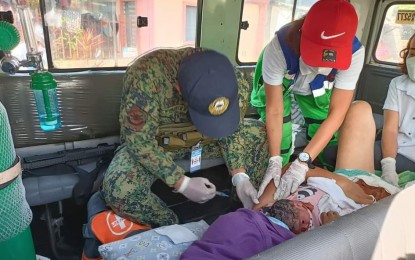 <p><strong>SAFE DELIVERY.</strong> Personnel from the Police Regional Office 5 (PRO5) led by Cpl. Leo John V. Samonte help a woman give birth inside a rescue vehicle in San Vicente, Camarines Norte on Monday (Jan. 17, 2022). Samonte is also a registered nurse.<em> (Photo courtesy of PRO5)</em></p>