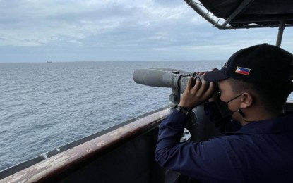 <p><strong>MARITIME PATROL</strong>. A Navy sailor aboard BRP-Andres Bonifacio (PS17) scans the Sibutu passage with a pair of binoculars in this undated photo as the Naval Forces Western Mindanao (NFWM), through the Naval Task Force 61, deployed the patrol ship in the area. The Sibutu passage and the tri-border of the Philippines, Malaysia, and Indonesia are among the critical sea lanes flowing with an immense volume of trades. <em>(Photo courtesy of NFWM)</em></p>