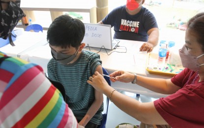 <p><strong>VAX FOR KIDS.</strong> A minor receives his Covid-19 vaccine at the newly-renovated Manila Zoo in Malate on Jan. 19, 2022. The zoo and Bagong Ospital ng Maynila will be the site of the initial rollout of vaccines for the 5 to 11 age group starting at 1 p.m. on Monday (Feb. 7, 2022). <em>(PNA photo by Avito Dalan)</em></p>
