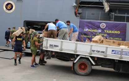 <p><strong>RELIEF MISSION.</strong> Philippine Navy personnel haul boxes of relief goods from the BRP Tarlac upon its arrival in Cebu for another relief mission on Tuesday (Jan. 18, 2022). The Navy said Wednesday (Jan. 19, 2022) these relief items would be distributed to typhoon-affected families in Cebu, Bohol, Surigao provinces, and Leyte. <em>(Photo courtesy of Naval Forces Central)</em></p>