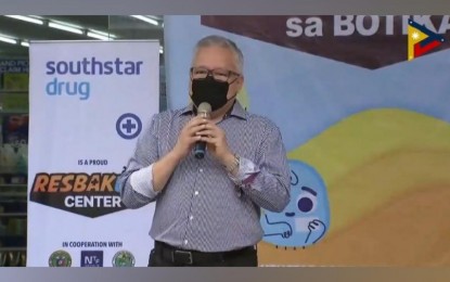<p><strong>‘RESBAKUNA SA BOTIKA’.</strong> Trade Secretary Ramon Lopez gives his message during the launch of "Resbakuna sa Botika" at the Southstar Drug branch in Bayan-Bayanan Ave. in Barangay Concepcion Uno, Marikina City on Thursday (Jan. 20, 2022). The new vaccination initiative aims to bring booster shots closer to the public. <em>(Screenshot from PTV)</em></p>