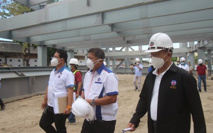 <p><strong>PROJECT INSPECTION.</strong> Public Works and Highways acting Secretary Roger G. Mercado (right) checks on the progress of projects being implemented in Pampanga on Friday (Jan. 21, 2022). He was welcomed by officials and employees of the department led by DPWH Regional Director Roseller Tolentino (center). <em>(Photo courtesy of DPWH-Central Luzon)</em></p>