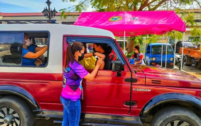 <p><strong>VACCINE BOOSTER.</strong> A vaccinator gives a motorist a booster shot at the Integrated Bus Terminal drive-through vaccination center in Zamboanga City on Saturday (Jan. 22, 2022) as the local government held its vaccine booster day. The activity aims to provide more protection to the residents of Zamboanga City amid the threat posed by the Omicron variant of Covid-19. <em>(Photo courtesy of City Hall Public Information Office) </em></p>