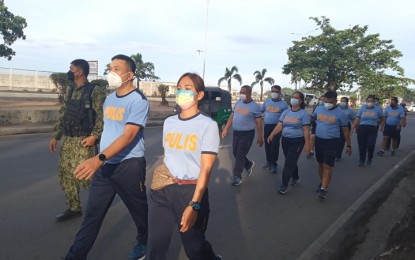 <p><strong>FITNESS PROGRAM.</strong> Col. Alexander Lorenzo, Zamboanga City Police Office (ZCPO) director (left), and Lt. Leah May Alameda, ZCPO information officer (right), lead a group of policemen in a brisk walk Saturday (Jan. 22, 2022) from Barangay Pasonanca to the city proper. The activity is part of the local police's physical fitness program, dubbed as the "10,000 steps program" that Lorenzo initiated upon his assumption as the new ZCPO head. <em>(Photo courtesy of ZCPO Public Information Office)</em></p>