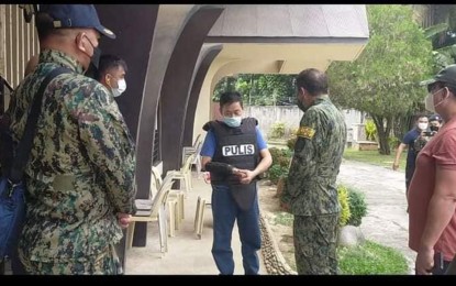 <p><strong>VOLUNTARY SURRENDER.</strong> Richard Gepte (center), 51, of Balingoan, Misamis Oriental was met by police personnel in the compounds of the Carmelite Monastery in Barangay Camaman-an, Cagayan de Oro City, following his surrender on Sunday (Jan. 23, 2022). The suspect has a warrant of arrest for allegedly masterminding the killing of Dr. Raul Winston Andutan, a hospital executive in the same city on Dec. 2, 2021. <em>(Photo courtesy of COCPO)</em></p>