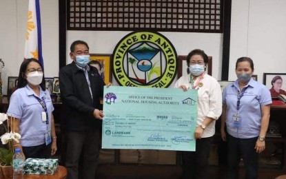 <p><strong>ASSISTANCE</strong>. Antique Governor Rhodora J. Cadiao (third from left) receives PHP5 million cash assistance from National Housing Authority (NHA) District Manager Jesus Fantilaga (second from left) to help families whose houses had been damaged by Typhoon Odette. Eby Archangel Butiong, Antique provincial housing board secretary, said on Wednesday (Jan. 26, 2022) that each qualified recipient will be receiving P5, 000 as assistance to rebuild their houses. <em>(Photo courtesy of Antique PIO)</em></p>